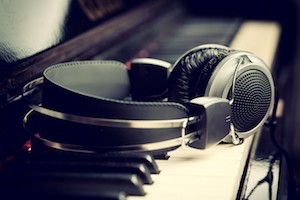 Piano keyboard with headphones for music